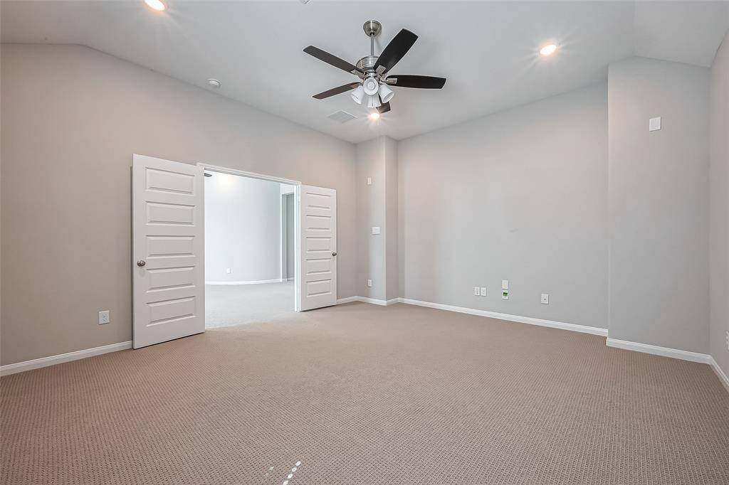Designed for immersive entertainment, this room features plush carpeting, recessed lighting, and a ceiling fan for added comfort. Double doors provide privacy, making it the perfect spot for movie nights or gaming marathons.
