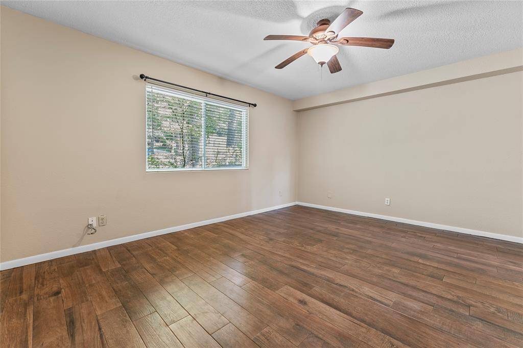 Primary bedroom downstairs - this home was recently updated with new flooring, paint and fixtures.