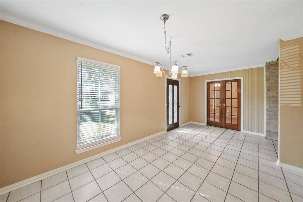 This thoughtfully designed one-story home includes a study with French doors and a spacious dining area.