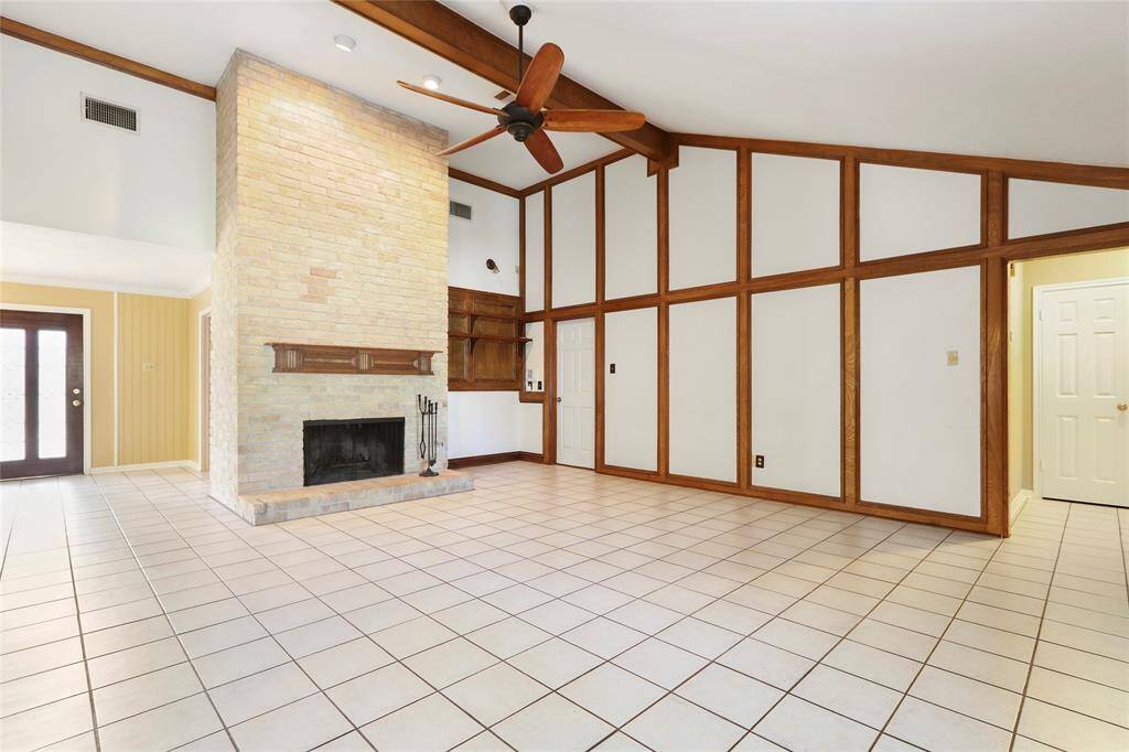 View of spacious living area and cozy fireplace.