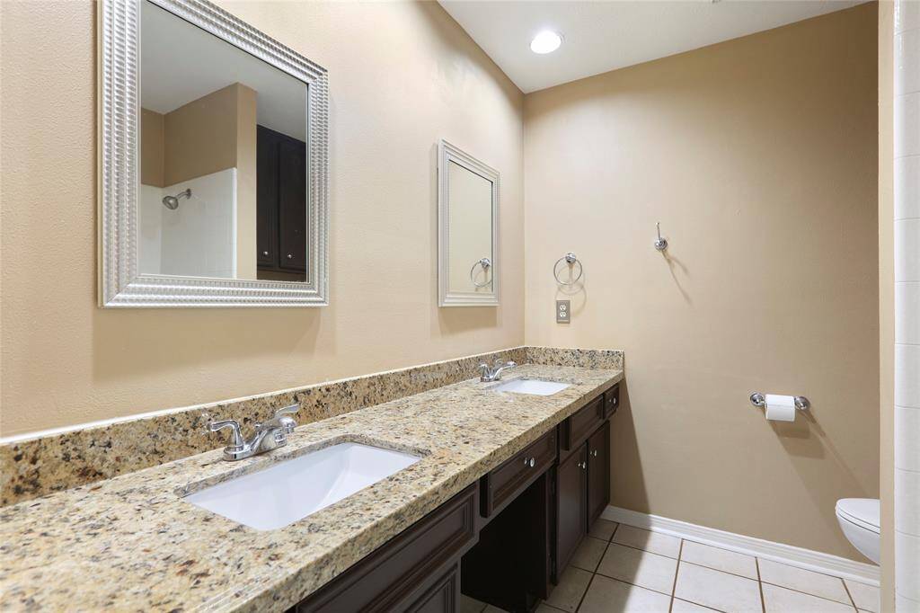 Secondary bathroom features double sinks.