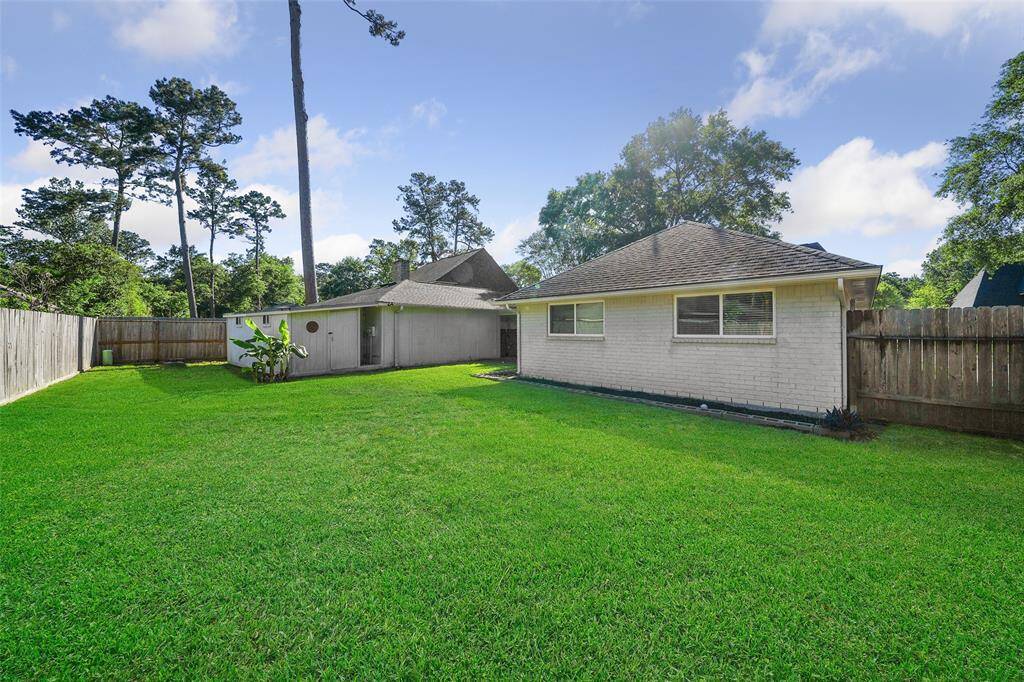 Garage has extension with entry door providing additional storage or workshop space.