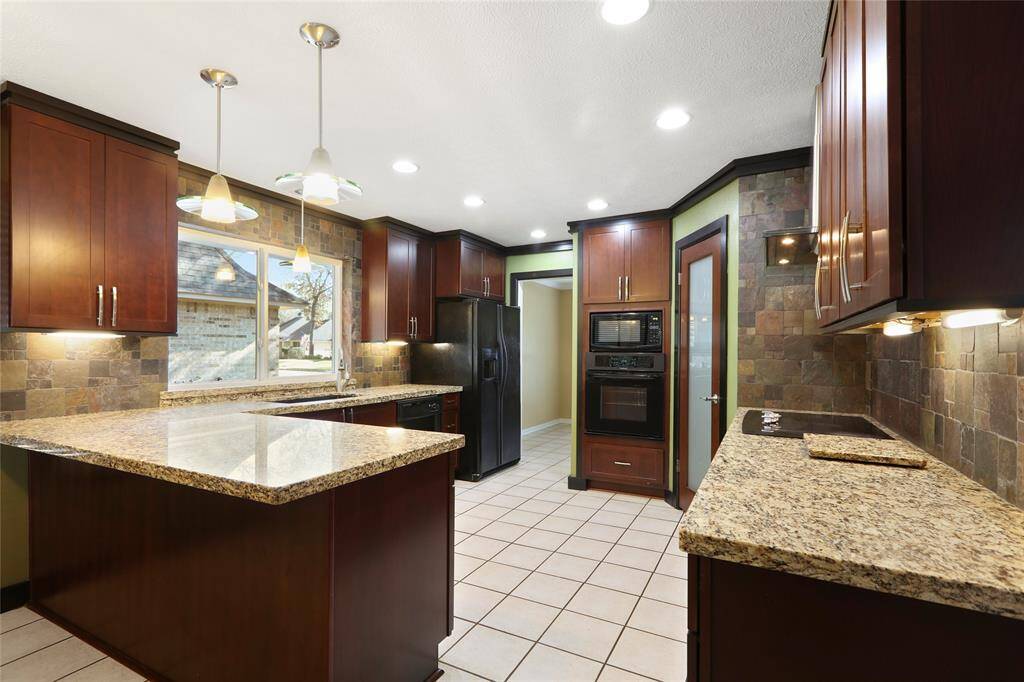 This beautifully updated kitchen features sleek under-cabinet lighting, soft-close drawers and a convenient breakfast bar.