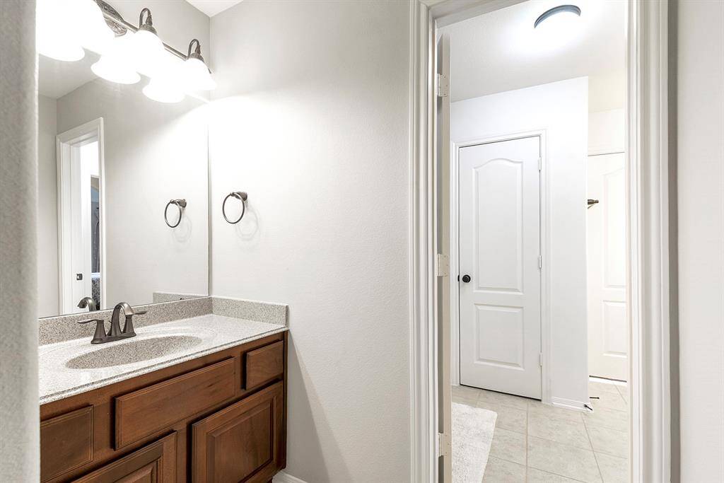 Each bedroom has its own vanity and shares a two-piece bathroom, featuring a shower-tub combo—providing both privacy and convenience for the occupants.