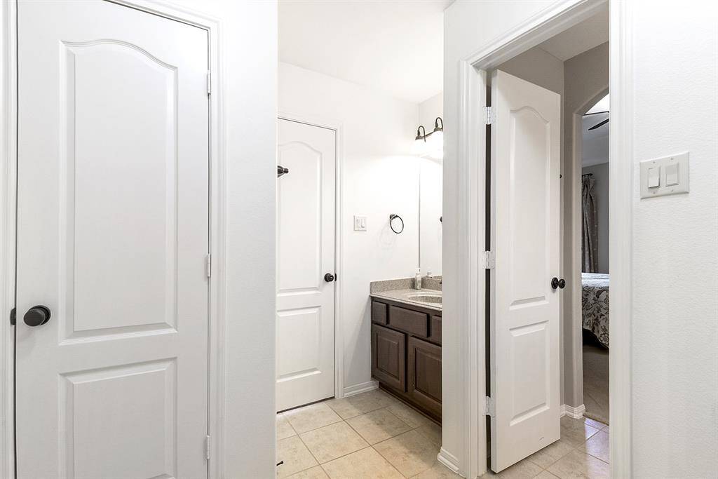Another view showcases the shared bathroom space, which offers plenty of room for multiple people to use it comfortably—making it ideal for families or guests.