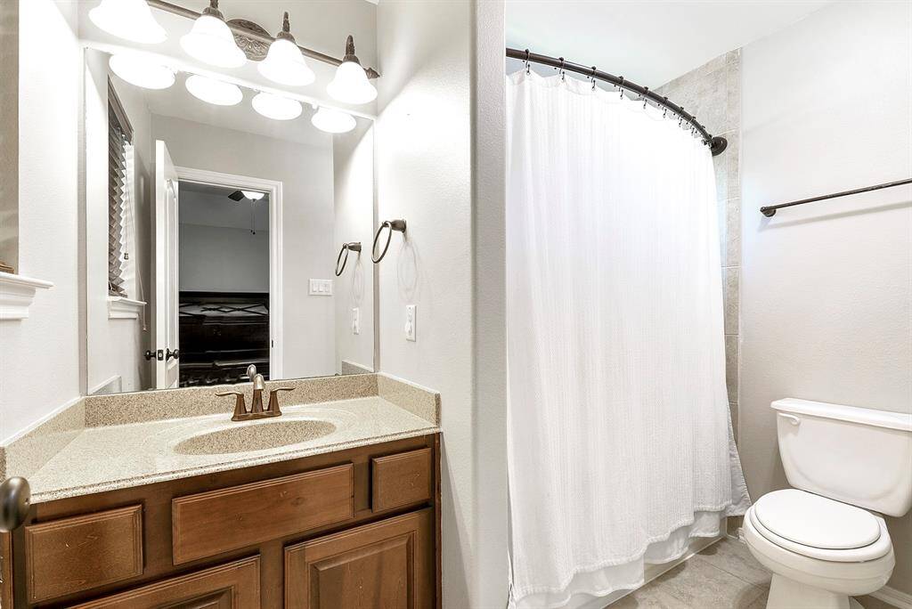 Attached to the upstairs junior en suite is a three-piece bathroom, featuring a full vanity with ample storage space, providing both convenience and functionality.