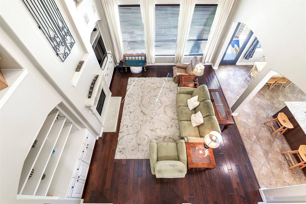 From upstairs, you can overlook the large living room, dining room, and breakfast room, with additional views extending out to the backyard, creating an open and connected feel throughout the home.