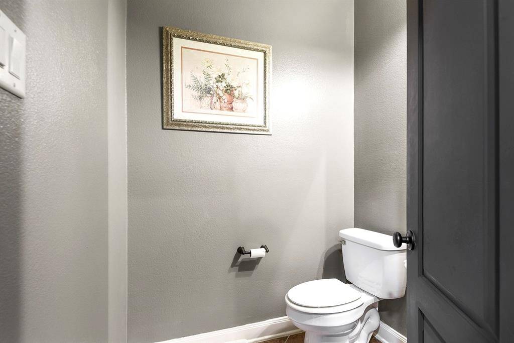 Downstairs features a half-bathroom, ideally located for privacy and guest use