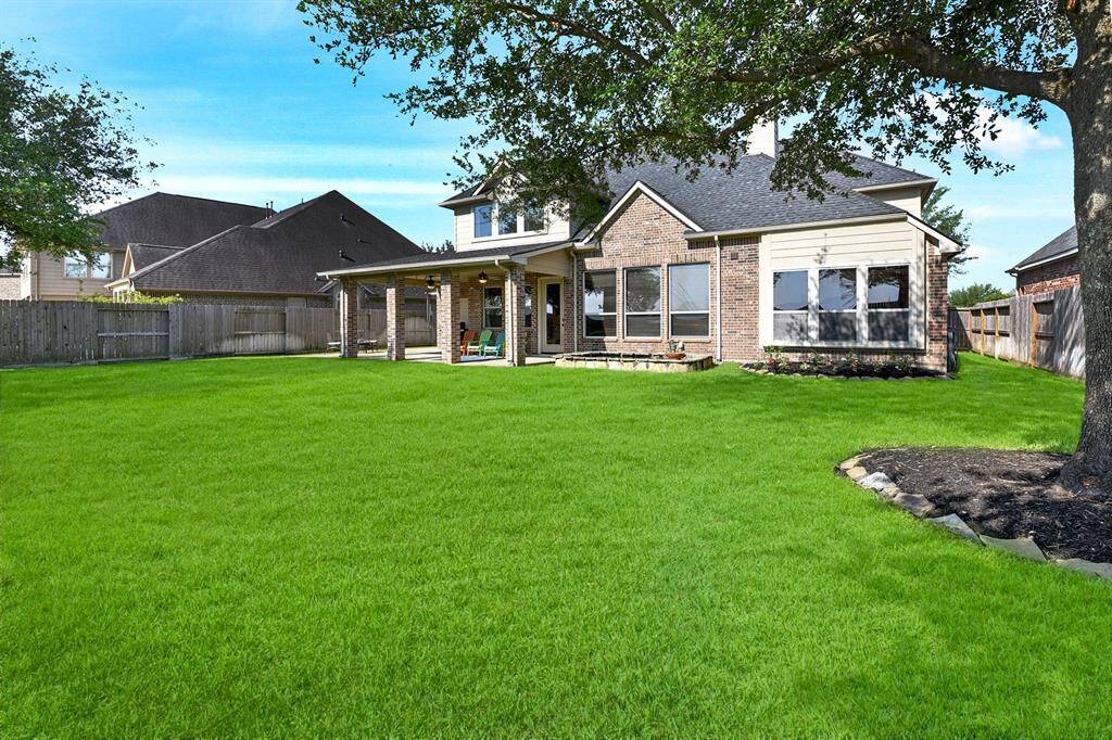 This nearly 3,500 square-foot home sits on a 12,000 square-foot lot, offering ample space to create your own outdoor oasis, perfect for gardening, hobbies, or sports. Notice the two backyard garage bays with a drive-through feature, providing easy access to the yard.