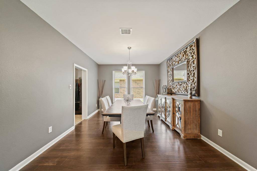 With easy access to the kitchen and foyer, this spacious dining room offers plenty of space for a large table and sideboard, making it ideal for entertaining in comfort and style.