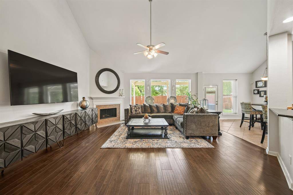 Soaring ceilings, wood flooring, and neutral finishes offer a warm and welcoming ambiance with plenty of space for relaxing or gathering with guests.