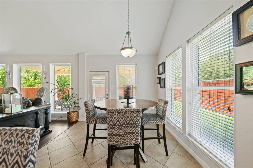 Surrounded by windows, this cheerful dining area is filled with natural light and offers tranquil views of the backyard.