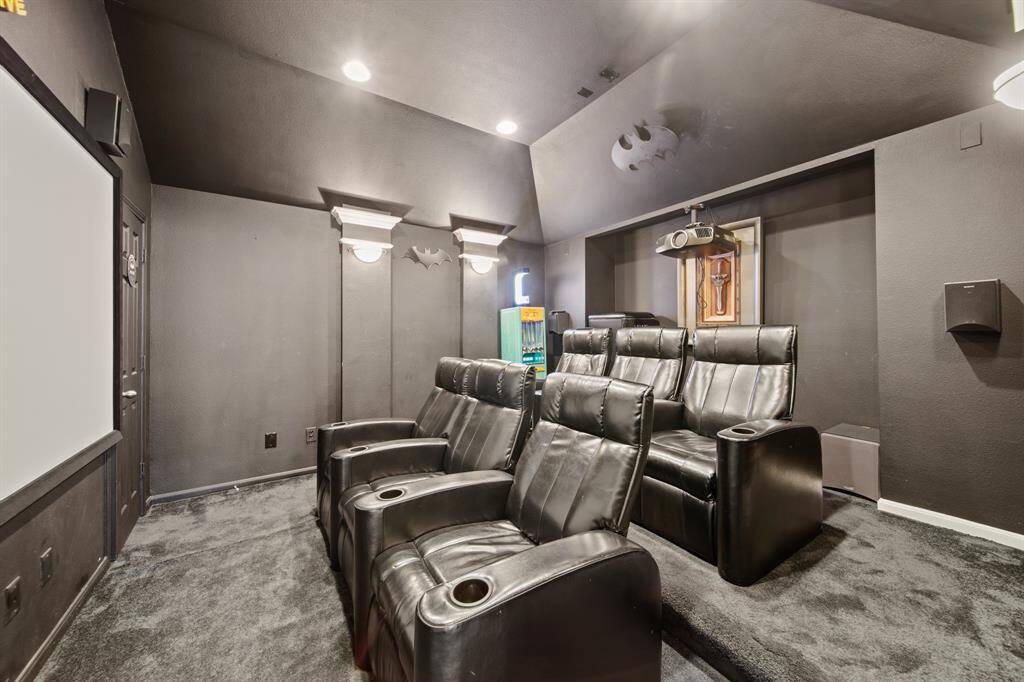 With darkened walls and a tiered layout, this enclosed media room is designed to elevate your home entertainment experience.