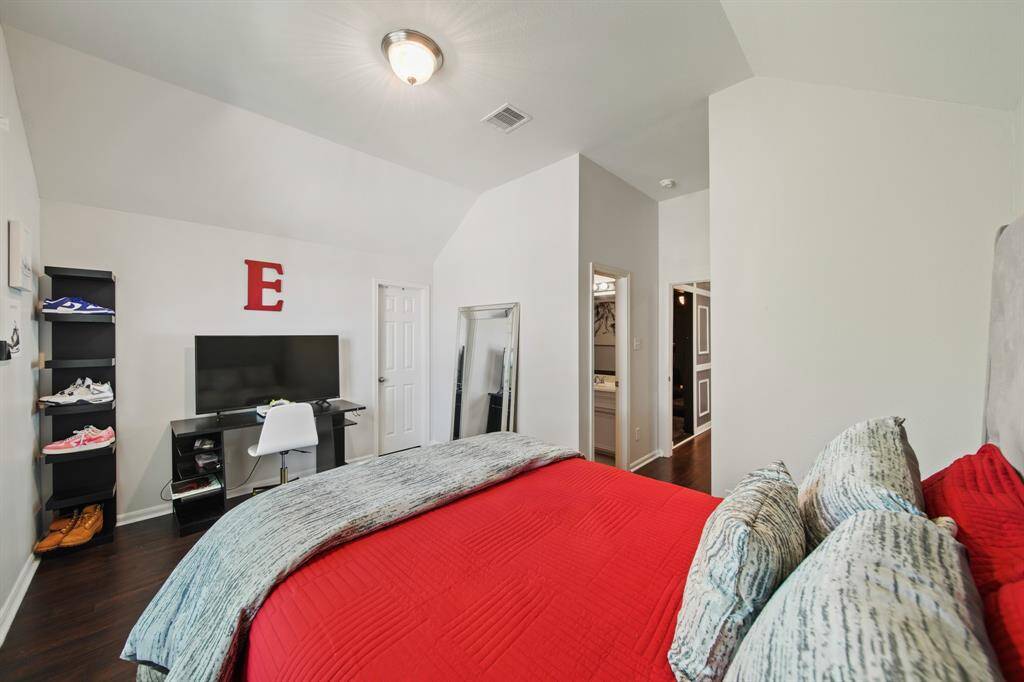 This upstairs guest suite features a generous layout, private access to the en-suite bath, and a walk-in closet to keep everything organized and tucked away.
