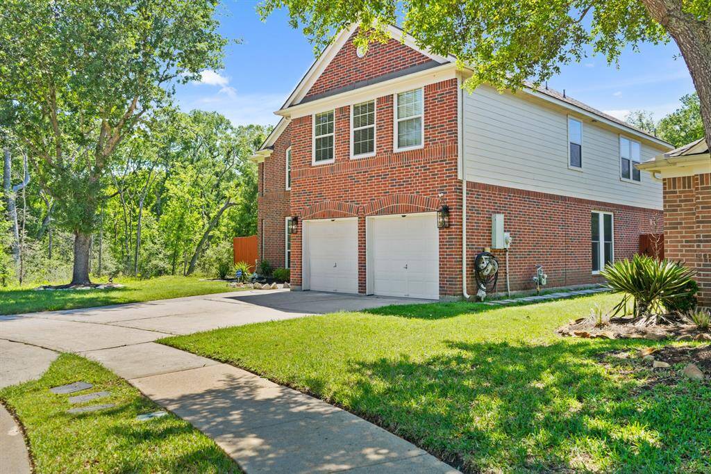 A curved sidewalk leads you to the welcoming covered front porch and elegant glass-panel entry door—setting the tone for the comfort inside.