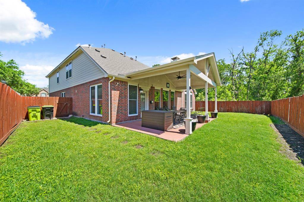The large fenced backyard offers both privacy and versatility, with plenty of green space for play, gardening, or future enhancements.