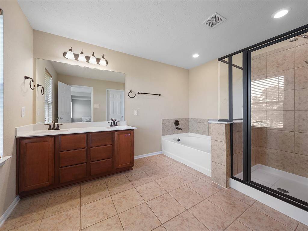 Primary bedroom shower and large soaking tub