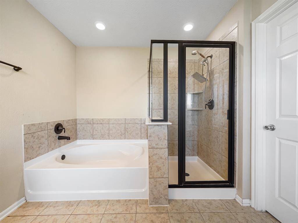 Large soaking tub and shower.