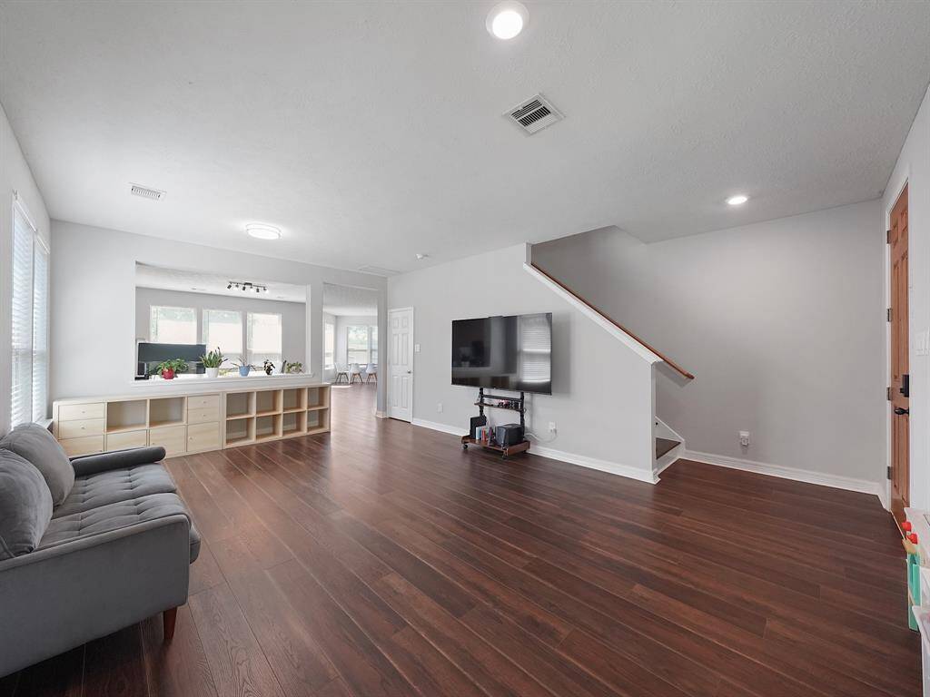 Spacious room being used as a Living room! Brand NEW Vinyl flooring.