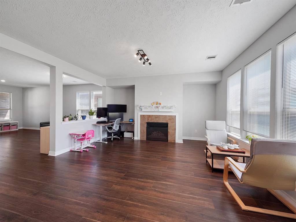 Very Spacious Living room with Gas log fireplace! Brand New Light fixture and NEW Vinyl Flooring!