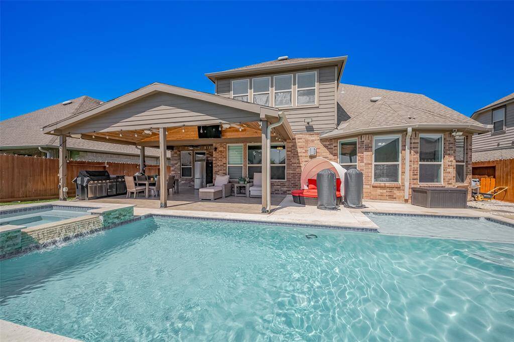 From the pool’s edge, take in the full view of the home’s outdoor retreat. The expansive covered patio, outdoor kitchen, and lounging zones make this backyard a true extension of indoor living—ideal for Texas summers and entertaining.