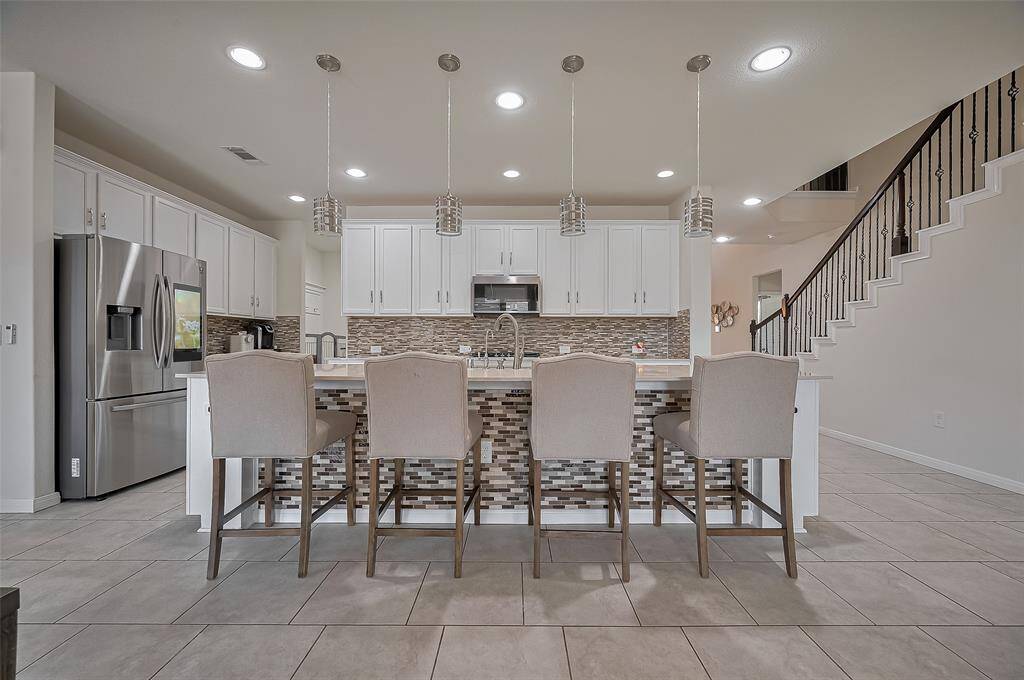 From the kitchen, you can enjoy open sightlines to the living room and beyond. This layout makes multitasking a breeze while entertaining or keeping an eye on family.