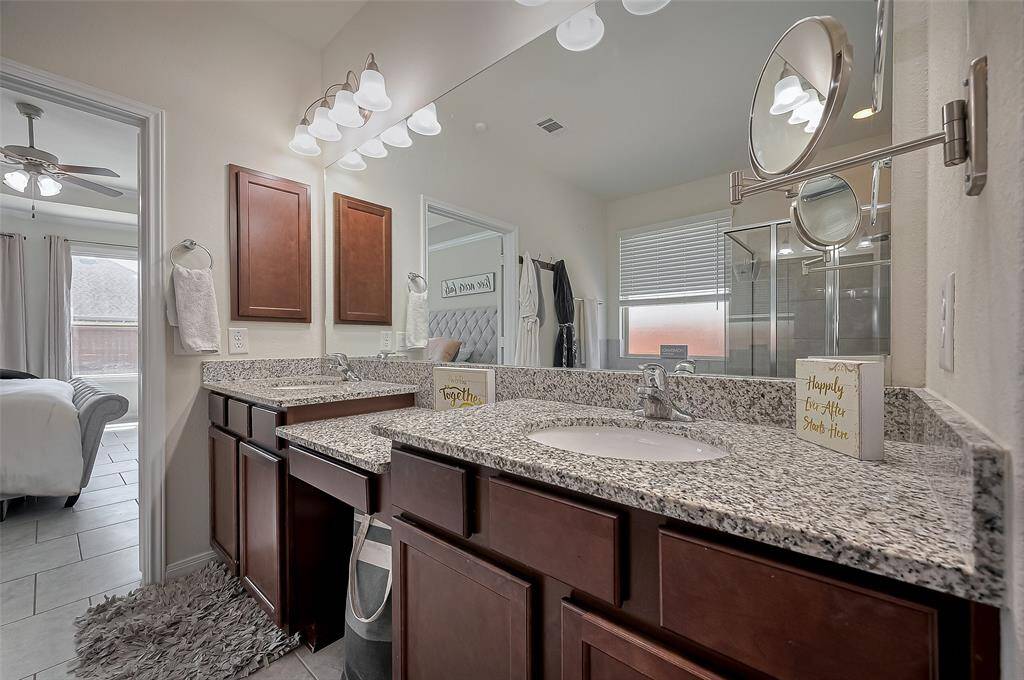 Unwind in the oversized soaking tub nestled beneath a frosted privacy window. Beautiful tilework and a relaxing atmosphere make this space a serene escape