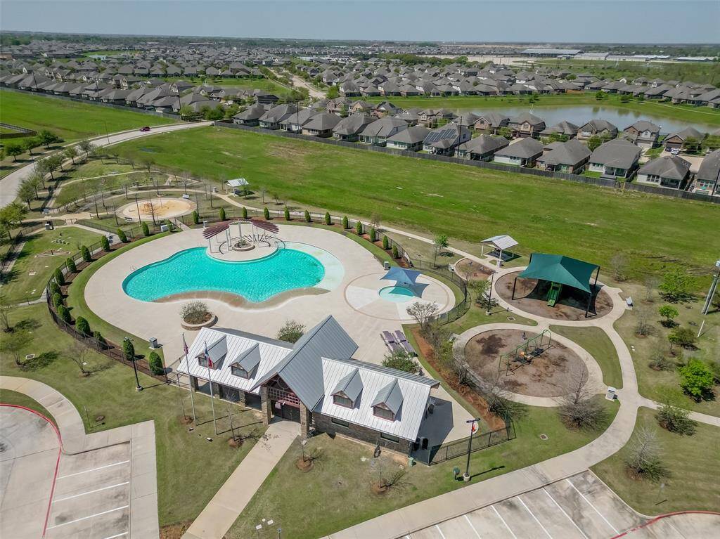 Bird’s-eye view highlighting the generous lot size, private pool area, and well-maintained backyard space — Walking distance at the end of the cul-de-sac to the community pool and playground spaces.