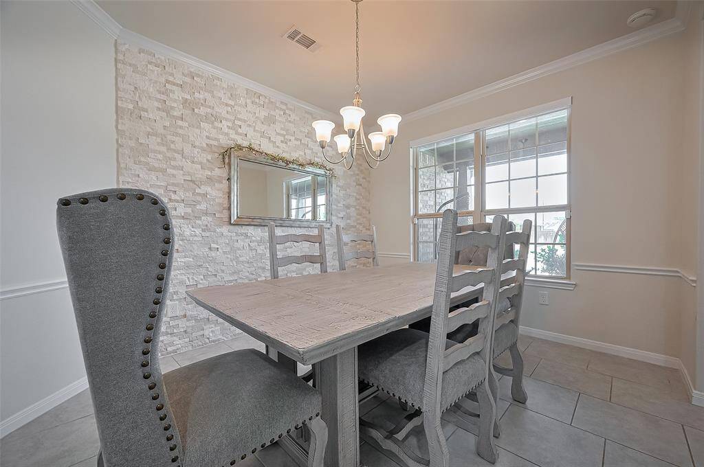 Staircase & Dining View:As you enter, you’re greeted by a graceful wooden staircase with wrought iron spindles and a formal dining room just off the foyer—perfect for entertaining guests in a warm, sophisticated space.