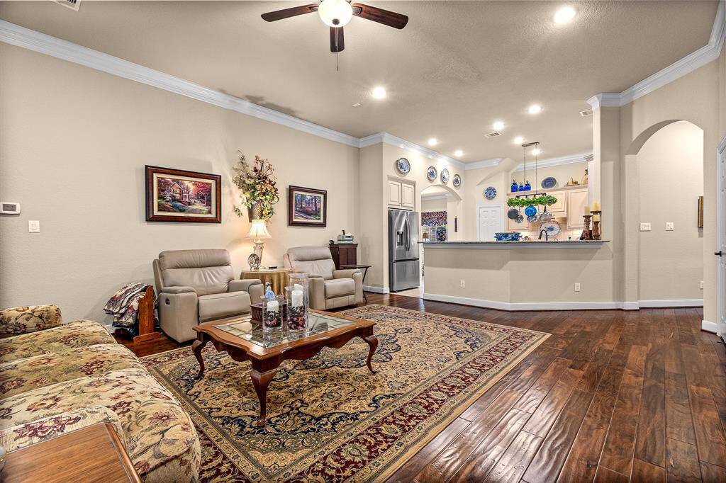 The Living room features an open layout with a spacious area. The Kitchen has a long Breakfast bar that makes watching the cook mix up delicious meals easy.  The cabinets offer under cabinet lighting and lighting above the cabinets. Everyone can enjoy this space making it ideal for relaxation and entertaining.