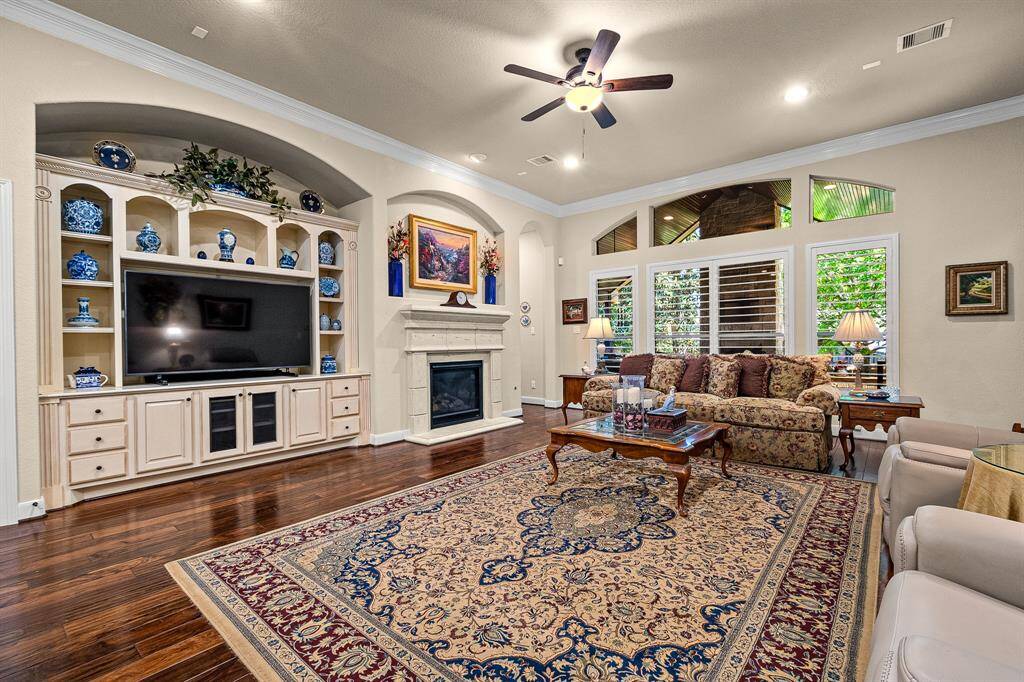 Your Living Room will allow most any furniture and features elegant hardwood floors, a gas fireplace, and built-in shelving and storage with decorative accents. The plantation shutters add the elegance you expect.