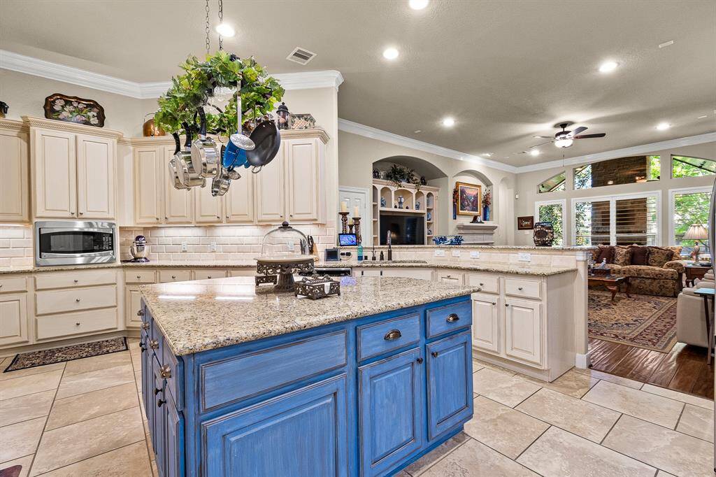 This Custom Kitchen features Granite countertops, a large island, massive amount of counterspace, gorgeous cabinetry with Pot and Pan drawersThe space is ideal for entertaining and family gatherings