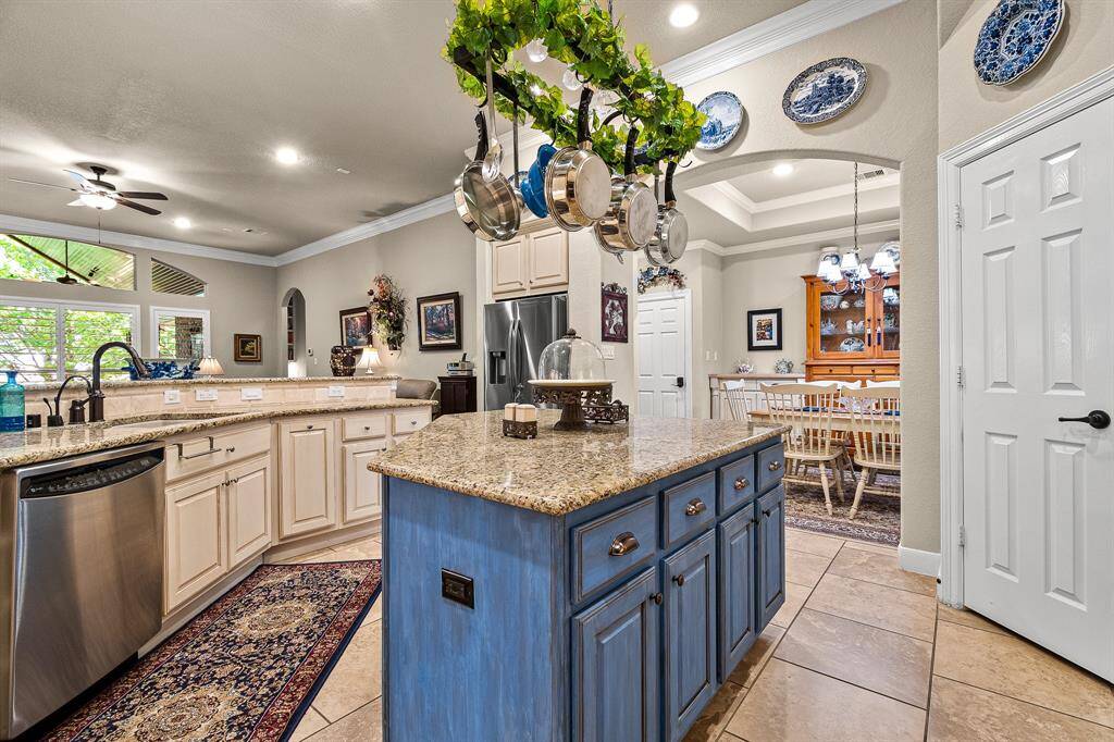 You'll never say that you need more storage!  This Kitchen provides a large amount of counter space and a HUGE Island.  The Pot Rack is handy and gorgeous! It adjoins to the Kitchen Dining area that offers a blend of functionality and charm.