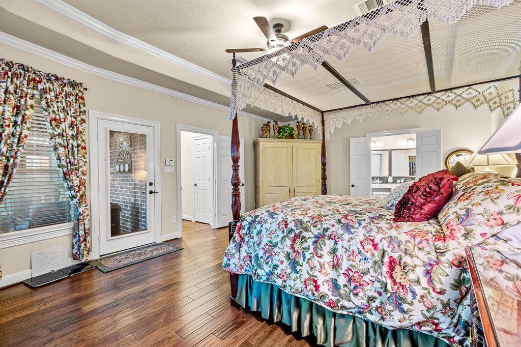 This Primary Suite makes you "Exhale" with all space which provides your relaxation.  Easy access to your outside covered Patio, and an en-suite bathroom visible through double doors.