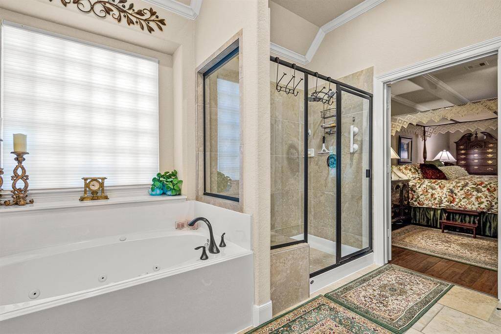 Your Primary Suite offers a luxurious bathroom with a Jetted tub and extra large walk in glass-enclosed shower that has a built in sitting area.  Adjacent to the bathroom is your inviitng Bedroom Suite.