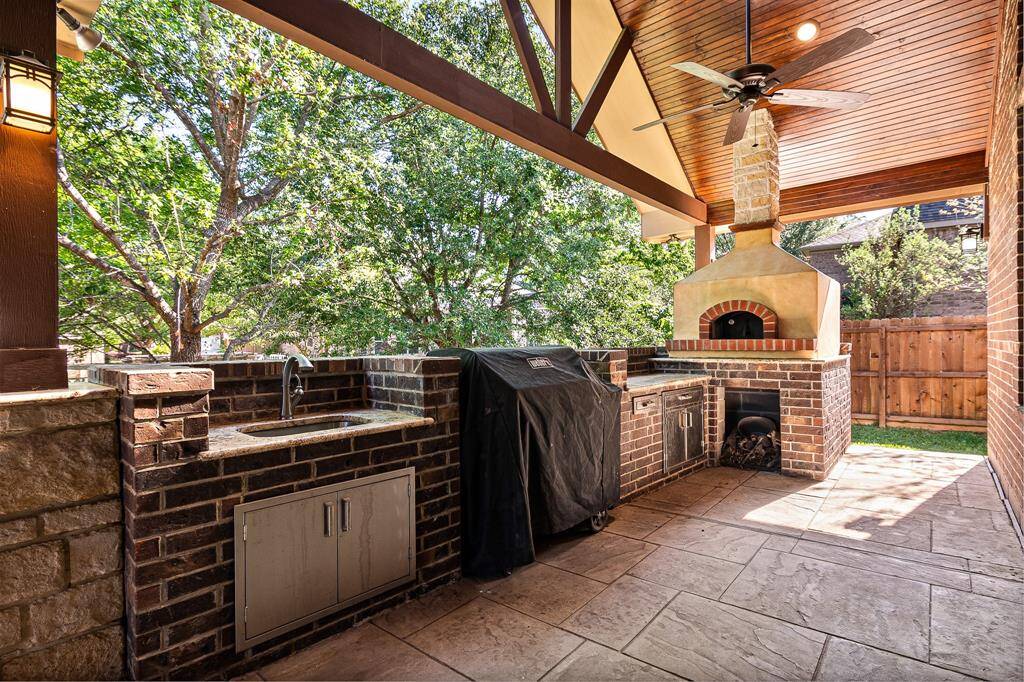 Calling all Cooks!  This outdoor Kitchen is made for you!  Sink with Hot & Cold Water, Weber Grill, Counterspace for prepping and a Custom wood burning Pizza Oven!  What else could you want?