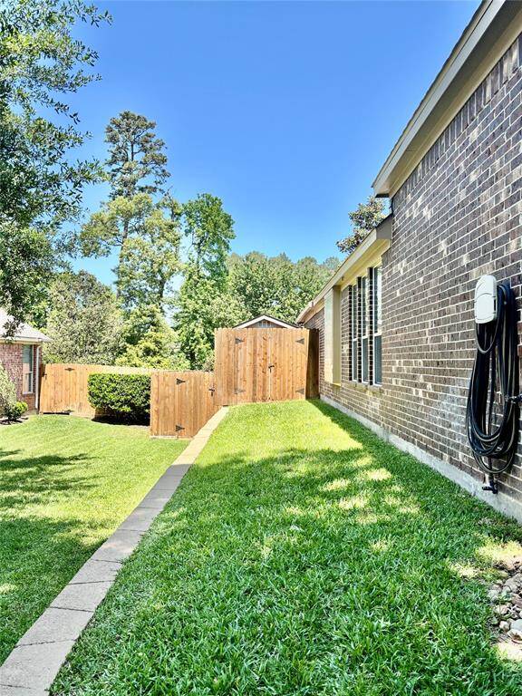 The Man/She Shed is conveniently located on the side of the house behind the fence.