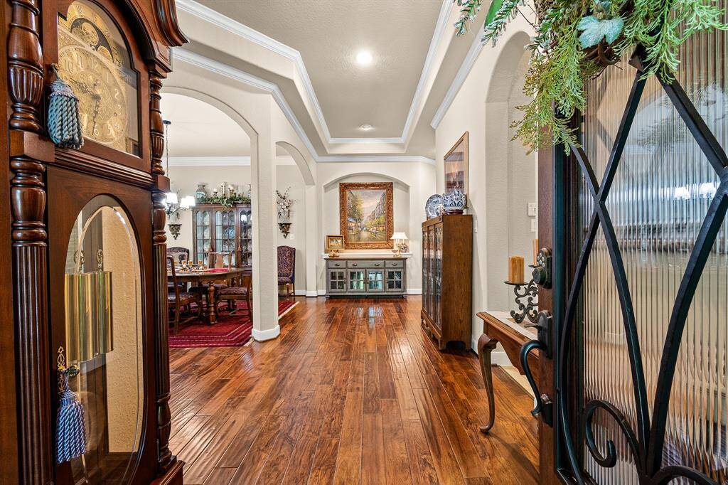 This elegant entryway welcomes you into this stately home. Trayed ceiling and decorative crown molding. It opens into a formal Dining area, creating a warm and inviting atmosphere.