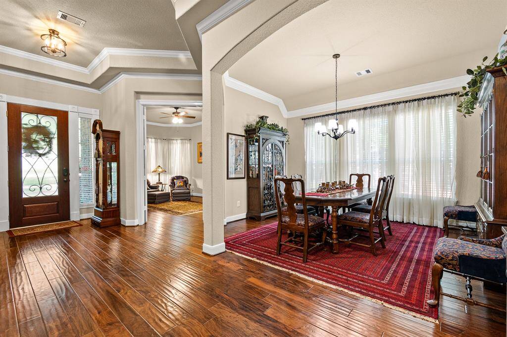 Welcoming entryway leading to your Home Office/Study and the Formal Dining Room.  Notice the trayed ceiling and elegant crown molding, and large windows that bring in natural light. The Formal Dining area is large enough for your credenza, buffet and large Diing Table which is creating a warm and inviting atmosphere.