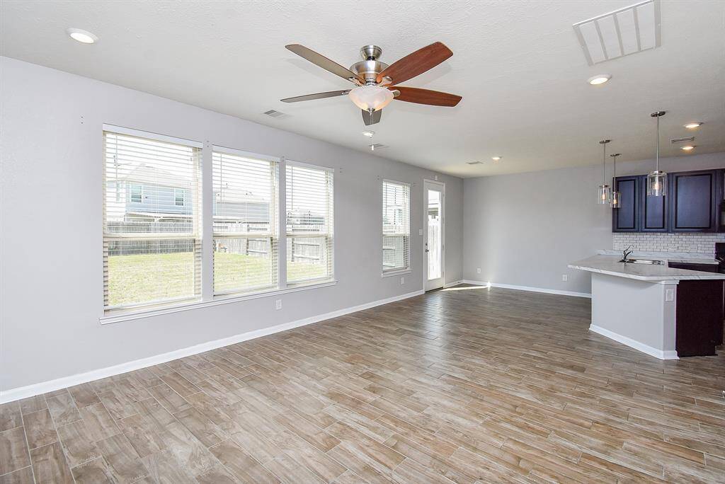 Step into a bright and airy living room with wide windows that let in plenty of natural light.
