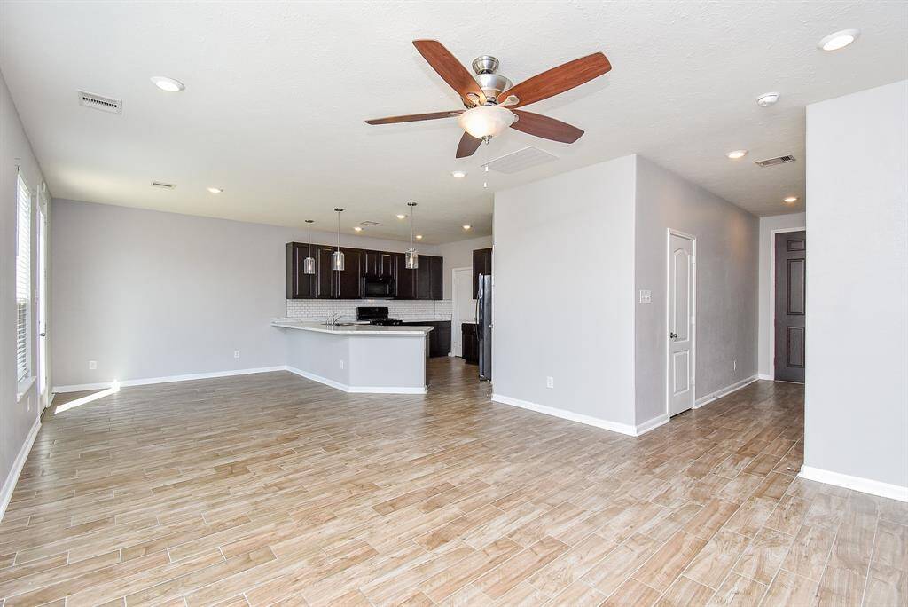 Gorgeous wood look tile flooring adds warmth and elegance to the space.