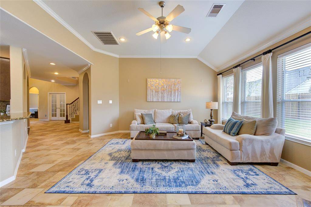 This inviting space flows seamlessly into the kitchen and breakfast area, creating the perfect layout for entertaining and everyday living.