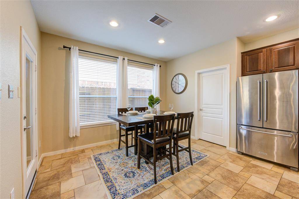 Bathed in natural light, the breakfast nook sits just off the kitchen and offers a charming place to enjoy casual meals with views of the backyard through oversized windows.