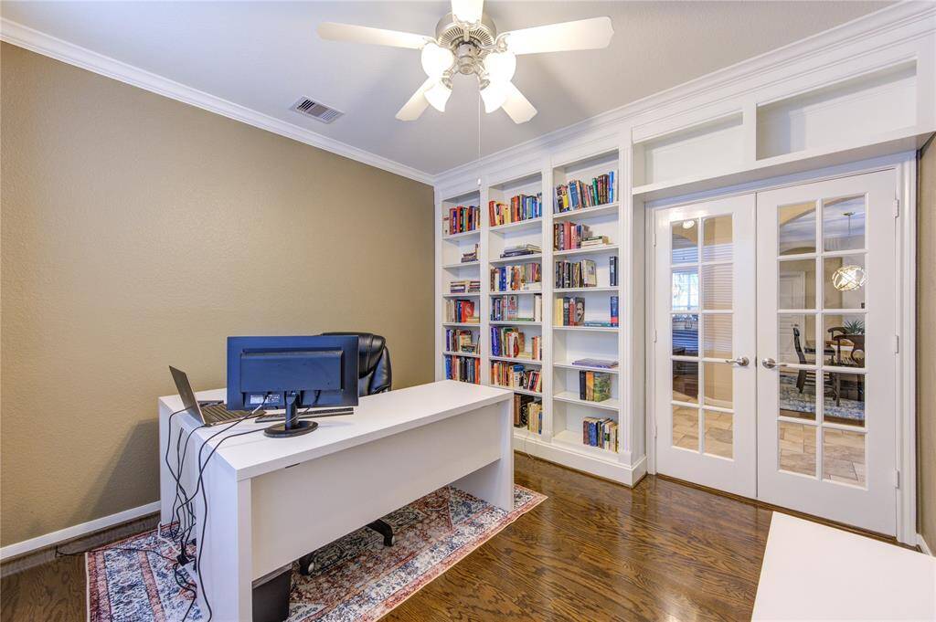 Just off the entry, the private study is enclosed with classic French doors and offers a quiet retreat for remote work or reading.