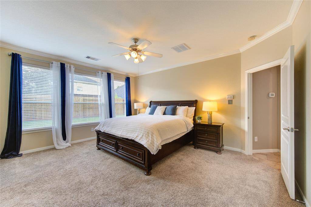This spacious primary bedroom offers a serene retreat with ample room for a king-size bed and cozy seating area.The neutral tones and thoughtful layout create a peaceful atmosphere, perfect for unwinding at the end of the day.