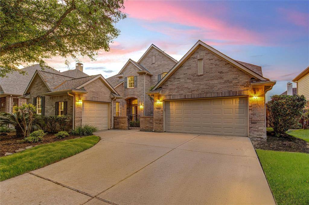 The spacious 3-car garage and wide driveway offer ample room for parking, storage, and hobbies.