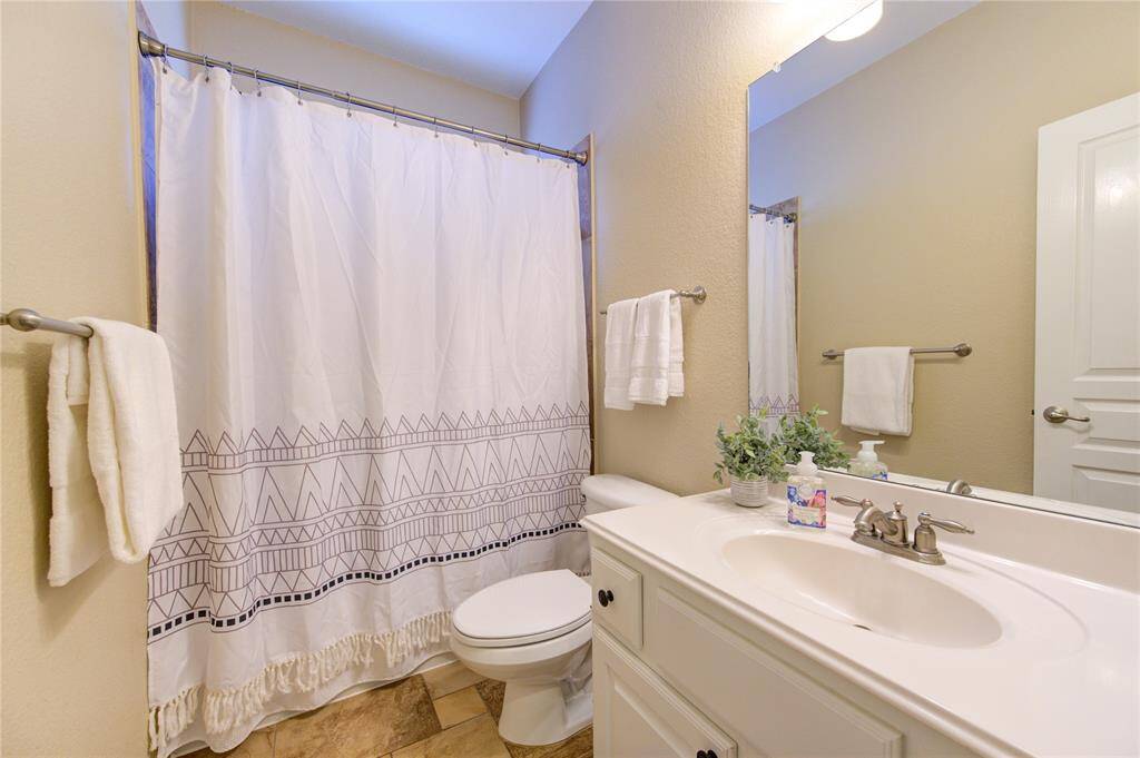 Conveniently located near the secondary bedroom, this full bath includes granite countertops and a tub/shower combo with timeless tile surround.