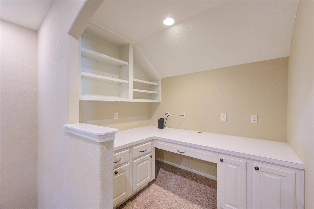 This separate built-in study area on the second floor provides a quiet, functional space for work or study. Featuring custom cabinetry, a comfortable workstation, and ample natural light, it’s the perfect spot for a home office, homework nook, or creative workspace. The open layout ensures easy access to the upstairs bedrooms and game room, while still maintaining a sense of privacy.