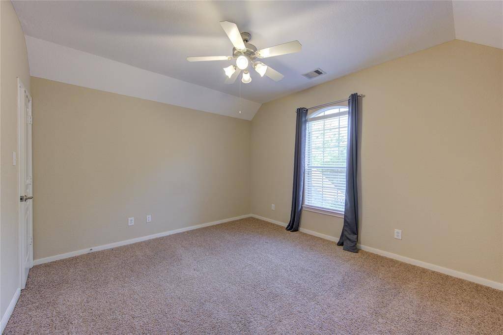 Three generously sized upstairs bedrooms each feature neutral carpet, large closets, ceiling fans, and easy access to the upstairs bathrooms—perfect for kids, guests, or a dedicated hobby room.
