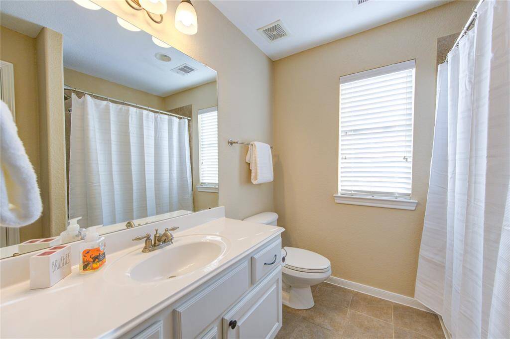 Two full bathrooms upstairs provide convenience and comfort with spacious vanities, granite counters, and modern tub/shower combinations with tile finishes.